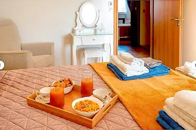 a table with a tray of food on a bed at A&B Ialysos villas and apartments in Ialyssos