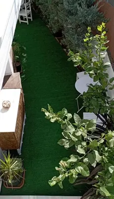 a garden with green grass and plants on a balcony at MARY'S APARTMENT in Paradissi in Paradeísion