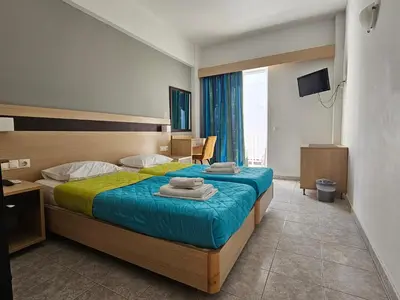 a hotel room with a bed with towels on it at G92 City Hotel in Rhodes Town