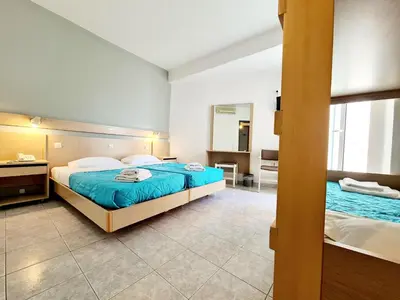 a bedroom with two beds and a mirror at G92 City Hotel in Rhodes Town