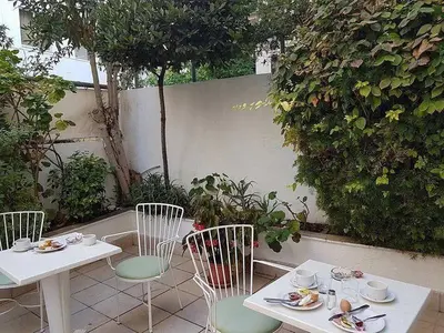 a table and chairs sitting on a patio at G92 City Hotel in Rhodes Town
