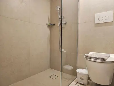 a bathroom with a glass shower with a toilet at G92 City Hotel in Rhodes Town
