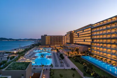 a view of a hotel with a pool and the ocean at Amada Colossos Resort in Faliraki