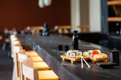 a table with sushi and rolls on top of it at Amada Colossos Resort in Faliraki