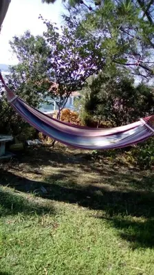 a hammock is hanging in a yard at Garden House with sea view in Faliraki