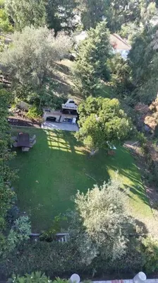 an aerial view of a yard with trees and a house at Garden House with sea view in Faliraki