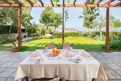 a table with oranges on it on a patio at Garden House with sea view in Faliraki