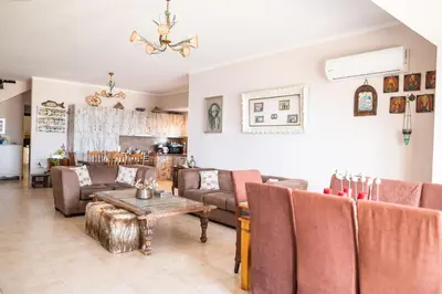 a living room with couches and a table at Irini's house afandou in Afantou