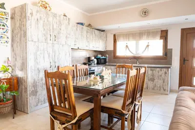 a kitchen with a dining room table and chairs at Irini's house afandou in Afantou