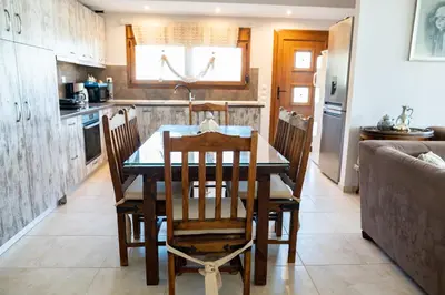 a kitchen with a table and chairs in a kitchen at Irini's house afandou in Afantou