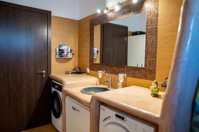 a bathroom with a sink and a washing machine at Irini's house afandou in Afantou