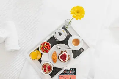 a tray with breakfast foods and a cup of coffee at Maison Du Jardin 2-Bedroom Apartment Private Outdoor Jacuzzi in Rhodes Town