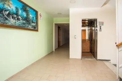 a hallway with a painting on the wall and a door at Hotel Africa in Rhodes Town