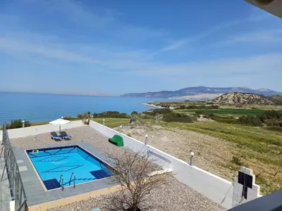 a swimming pool with a view of the water at Pearl Villas Apolakkia - Beach Front Villas with Private Pool in Apolakkiá
