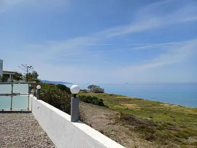 a white wall with a view of the ocean at Pearl Villas Apolakkia - Beach Front Villas with Private Pool in Apolakkiá