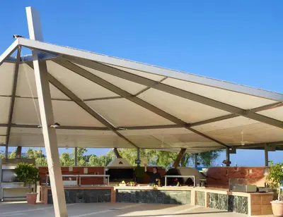 a pavilion with awning over a patio at Apollo Beach in Faliraki