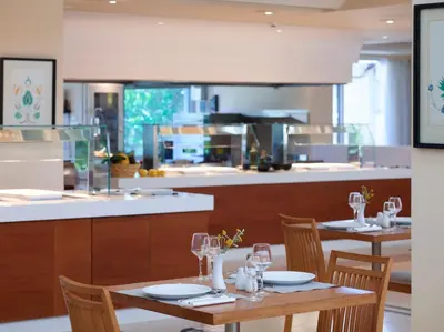 a dining room with two tables and a kitchen at Apollo Beach in Faliraki