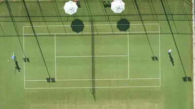 an overhead view of a tennis court with people on it at Apollo Beach in Faliraki