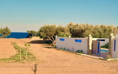 a house on the side of a dirt road at Beach Pearl - Beach Front House with Private Pool in Gennadi