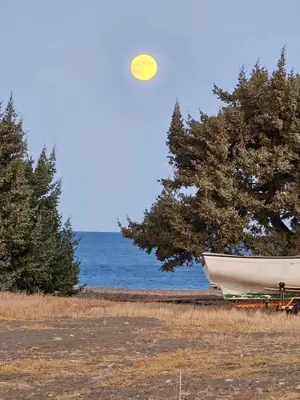 a yellow frisbee flying in the air over a boat at Beach Pearl - Beach Front House with Private Pool in Gennadi