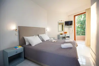 a bedroom with a bed with two towels on it at John Mary in Faliraki