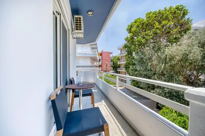 a small table on the balcony of a building at Rhodes Island Elli Beach Apartments in Rhodes Town