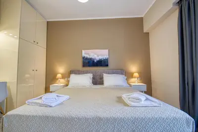 a bedroom with a bed with two towels on it at Rhodes Island Elli Beach Apartments in Rhodes Town