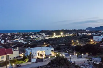a view of a city at night at Sebastian Villas in Afantou