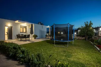 a backyard at night with a gazebo at Sebastian Villas in Afantou