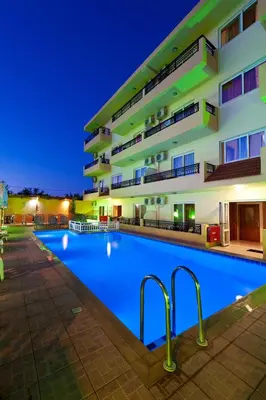 a large swimming pool in front of a building at Alea Hotel Apartments in Ialyssos
