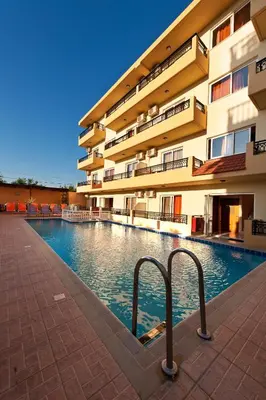 a swimming pool in front of a building at Alea Hotel Apartments in Ialyssos