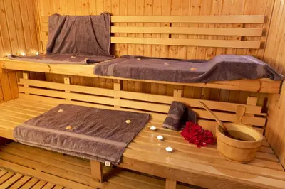 a sauna with a bed and a table in it at Lydia Maris Resort & Spa in Kolimbia