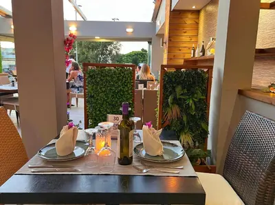 a table with plates and napkins on top at Caravel Hotel Apartments in Ixia