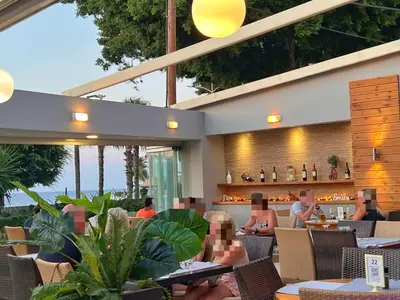 a restaurant with people sitting at tables at Caravel Hotel Apartments in Ixia