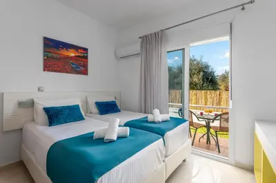 two beds in a bedroom with a balcony at Amazing Summer Villa in Kolimbia
