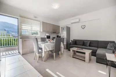 a living room with a table and a couch at Casa Stergos 2apts in Archangelos