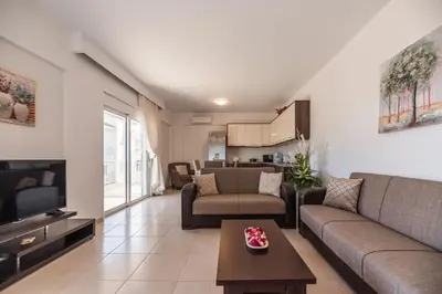 a living room with a couch and a tv at Casa Stergos 2apts in Archangelos