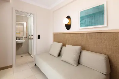 a living room with a couch and a bathroom at Electra Palace Rhodes - Premium All Inclusive in Ialyssos
