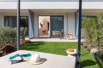a patio with a table with a hat on it at Electra Palace Rhodes - Premium All Inclusive in Ialyssos