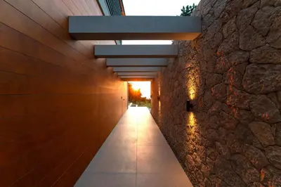 a hallway of a building with a stone wall at Villa Casa Palmera in Ixia