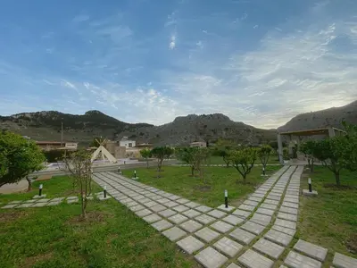 a walkway in a park with mountains in the background at LA Casa Di Lusso N3 - Adults Only in Kolimbia