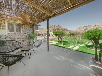 a patio with a table and chairs and a view of a yard at LA Casa Di Lusso N3 - Adults Only in Kolimbia