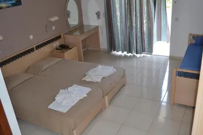 a bedroom with a bed with towels on it at White Palace Studios in Faliraki