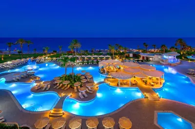 an aerial view of a resort pool at night at Rodos Palladium Leisure & Wellness in Faliraki