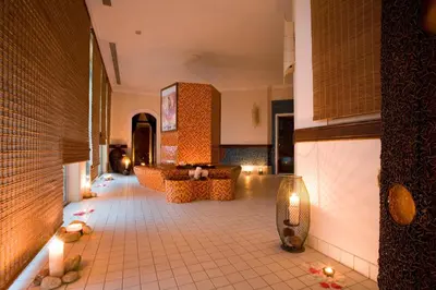 a lobby with a couch and candles on a tiled floor at Rodos Palladium Leisure & Wellness in Faliraki