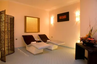 a waiting room with two chairs and a mirror at Rodos Palladium Leisure & Wellness in Faliraki