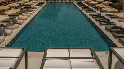 an overhead view of a swimming pool with lounge chairs at Eleonas Boutique Hotel & Spa - Adults Only in Ialyssos