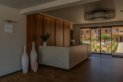 a lobby with two white vases on the floor at Eleonas Boutique Hotel & Spa - Adults Only in Ialyssos