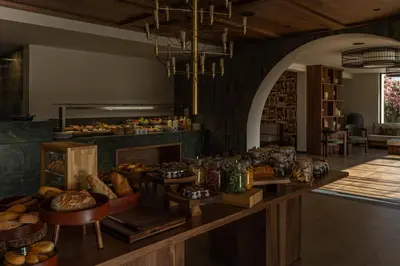 a kitchen with a counter with bread and other foods at Eleonas Boutique Hotel & Spa - Adults Only in Ialyssos