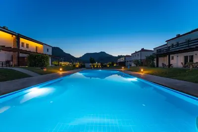 a swimming pool in a villa at night at Posidonia Luxury Villas Kolympia in Kolimbia